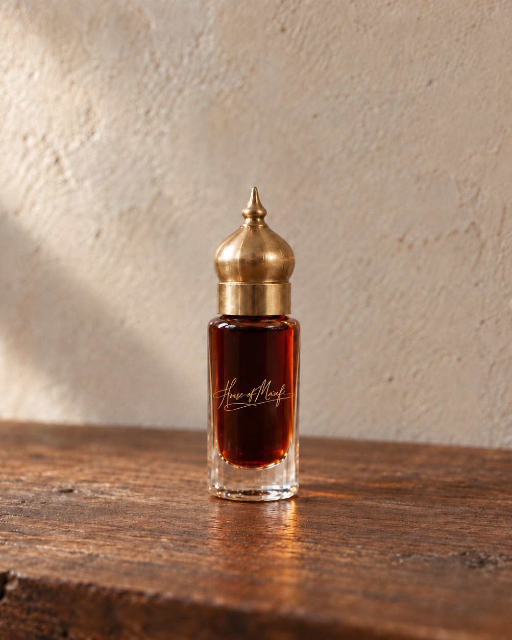 House oud blend in a glass bottle with a brass cap